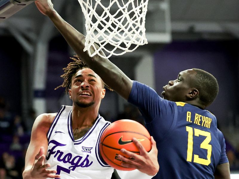 Feb 12, 2024; Fort Worth, Texas, USA;  TCU Horned Frogs forward Chuck O'Bannon Jr. (5) shoots as West Virginia Mountaineers forward Akok Akok (13) defends during the first half at Ed and Rae Schollmaier Arena. Mandatory Credit: Kevin Jairaj-USA TODAY Sports