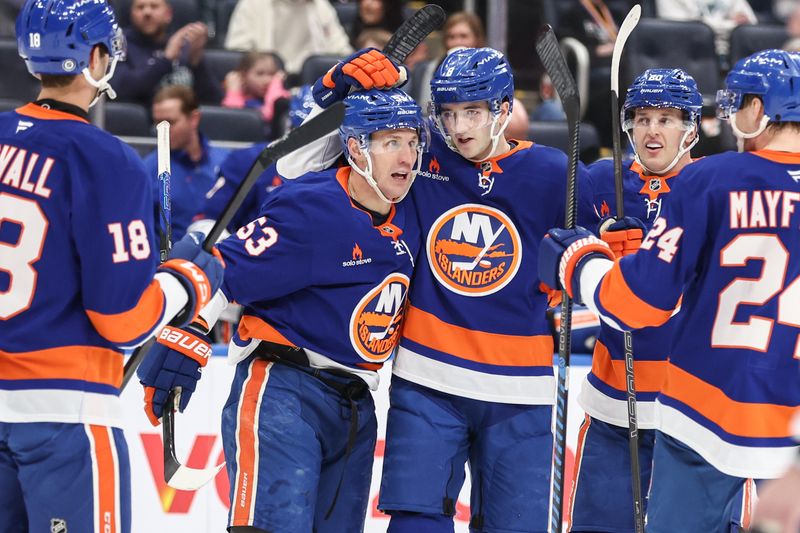 Apr 4, 2025; Elmont, New York, USA;  New York Islanders center Casey Cizikas (53) celebrates with his teammates after scoring a goal in the second period against the Minnesota Wild at UBS Arena. Mandatory Credit: Wendell Cruz-Imagn Images
