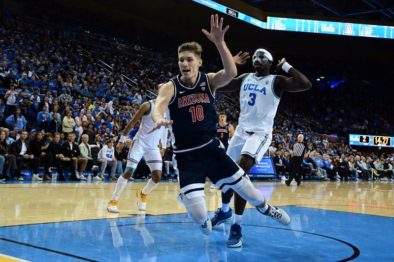 Mar 4, 2023; Los Angeles, California, USA;  Arizona Wildcats forward Azuolas Tubelis (10) drives to the basket and UCLA Bruins forward Adem Bona (3) defends during the first half at Pauley Pavilion presented by Wescom. Mandatory Credit: Richard Mackson-USA TODAY Sports