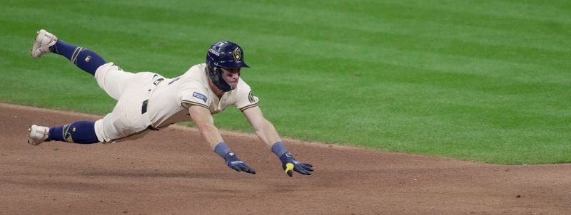 Oct 1, 2024; Milwaukee, Wisconsin, USA; Milwaukee Brewers outfielder Sal Frelick (10) dives after hitting a double during the fourth inning of their wild-card playoff game against the New York Mets at American Family Field. Mandatory Credit: Mark Hoffman/USA TODAY Network via Imagn Images