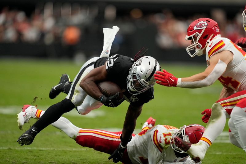 Las Vegas Raiders running back Alexander Mattison (22) runs with the ball during the first half of an NFL football game against the Kansas City Chiefs Sunday, Oct. 27, 2024, in Las Vegas. (AP Photo/John Locher)