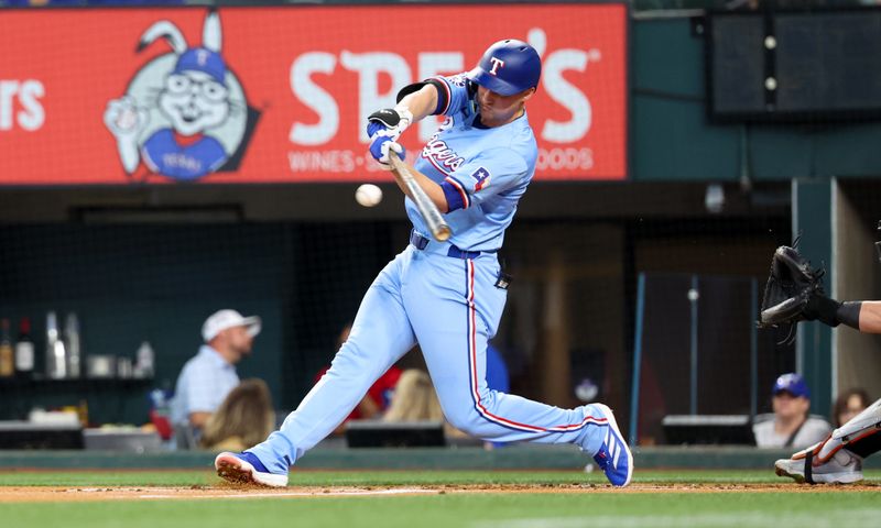 Jul 21, 2024; Arlington, Texas, USA;  Texas Rangers shortstop Corey Seager (5) hits a single during the first inning against the Baltimore Orioles at Globe Life Field. Mandatory Credit: Kevin Jairaj-USA TODAY Sports