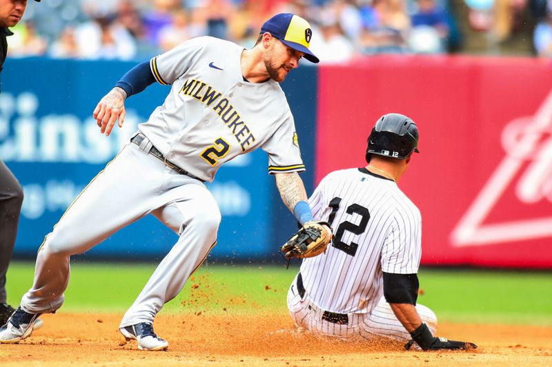 Sep 10, 2023; Bronx, New York, USA; New York Yankees third baseman Isiah Kiner-Falefa (12) beats the tag of Milwaukee Brewers second baseman Brice Turang (2) for a stolen base in the fifth inning at Yankee Stadium. Mandatory Credit: Wendell Cruz-USA TODAY Sports