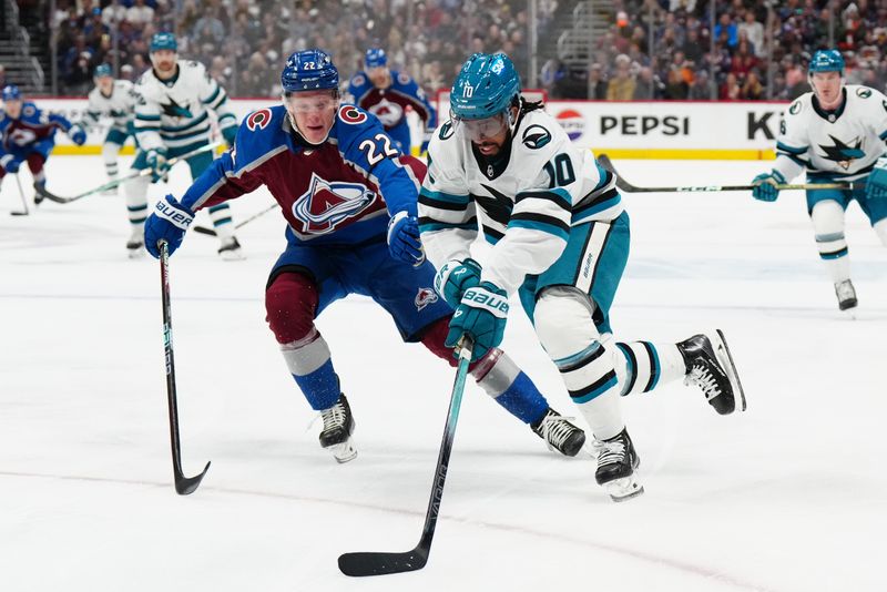 Dec 31, 2023; Denver, Colorado, USA; San Jose Sharks left wing Anthony Duclair (10) skates past Colorado Avalanche left wing Fredrik Olofsson (22) in the first period at Ball Arena. Mandatory Credit: Ron Chenoy-USA TODAY Sports