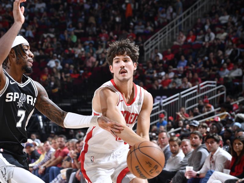 HOUSTON, TX - NOVEMBER 6:  Reed Sheppard #15 of the Houston Rockets passes the ball during the game against the San Antonio Spurs on November 6, 2024 at the Toyota Center in Houston, Texas. NOTE TO USER: User expressly acknowledges and agrees that, by downloading and or using this photograph, User is consenting to the terms and conditions of the Getty Images License Agreement. Mandatory Copyright Notice: Copyright 2024 NBAE (Photo by Logan Riely/NBAE via Getty Images)