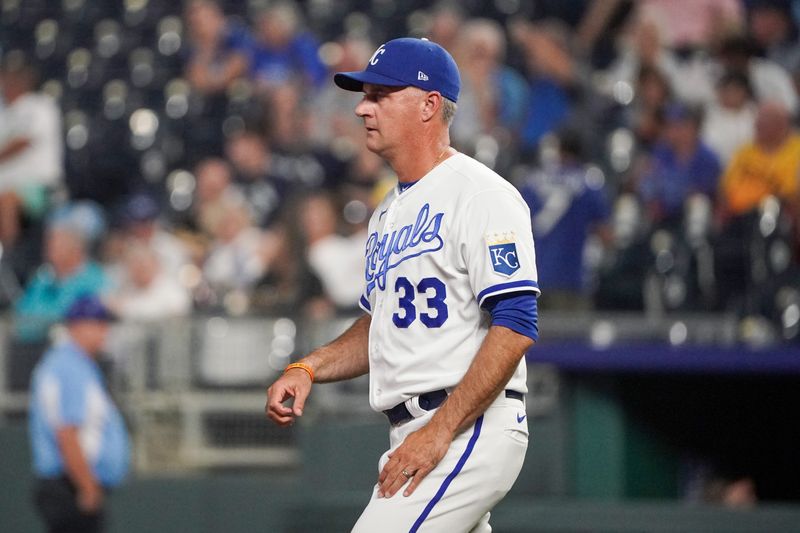 Aug 29, 2023; Kansas City, Missouri, USA; Kansas City Royals manager Matt Quatraro (33) comes to the mound against the Pittsburgh Pirates for a pitching change in the ninth inning at Kauffman Stadium. Mandatory Credit: Denny Medley-USA TODAY Sports