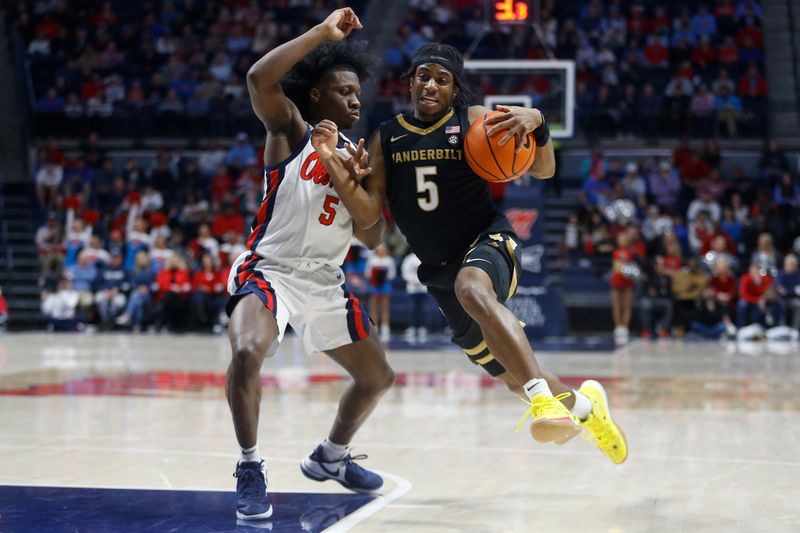 Jan 13, 2024; Oxford, Mississippi, USA; Vanderbilt Commodores guard Ezra Manjon (5) drives to the basket as Mississippi Rebels guard Jaylen Murray (5) defends during the first half at The Sandy and John Black Pavilion at Ole Miss. Mandatory Credit: Petre Thomas-USA TODAY Sports