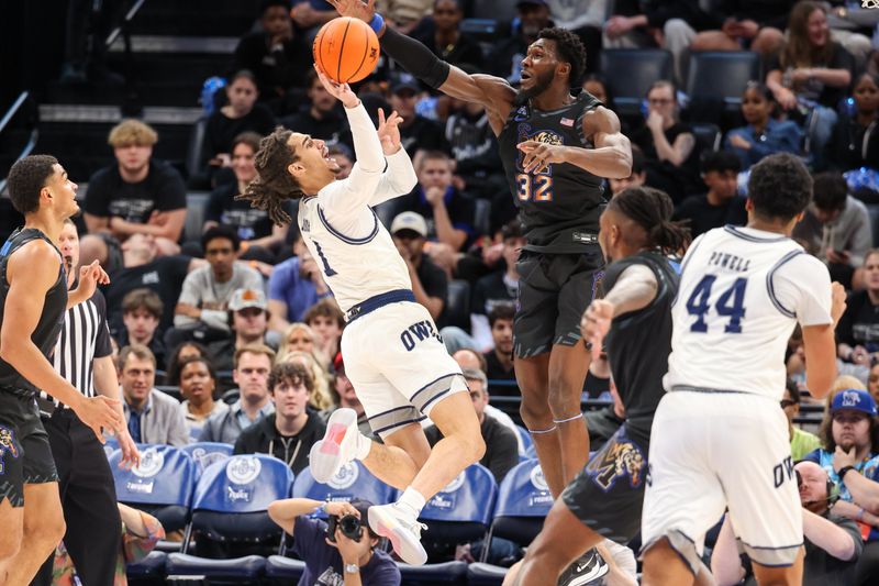 Feb 26, 2025; Memphis, Tennessee, USA; Rice Owls guard Kellen Amos (1) shoots against Memphis Tigers center Moussa Cisse (32) during the first half at FedExForum. Mandatory Credit: Wesley Hale-Imagn Images