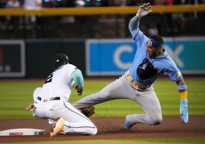 Jun 29, 2023; Phoenix, Arizona, USA; Arizona Diamondbacks infielder Geraldo Perdomo (2) tags out Tampa Bay Rays shortstop Wander Franco (5) on a steal attempt at Chase Field. Mandatory Credit: Joe Rondone-USA TODAY Sports