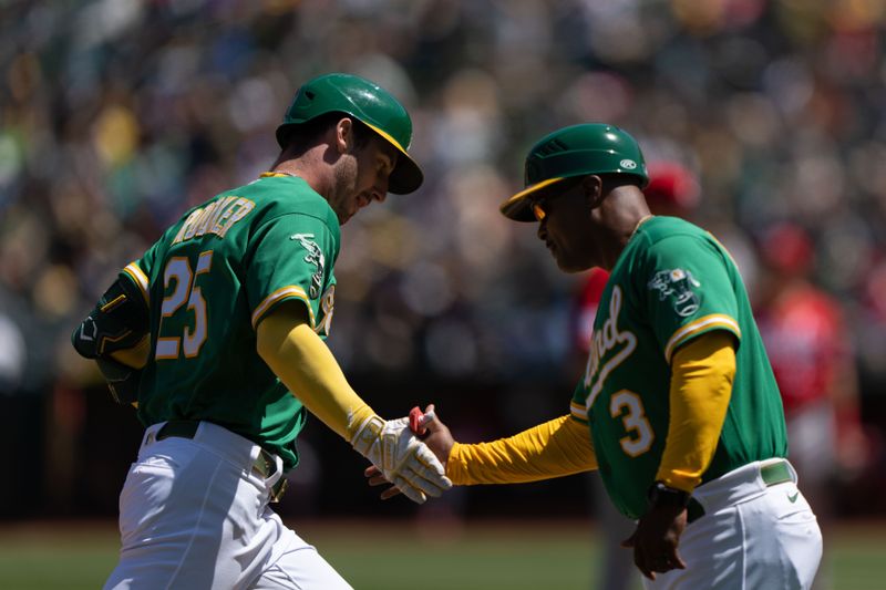 Apr 30, 2023; Oakland, California, USA;  Oakland Athletics left fielder Brent Rooker (25) celebrates with third base coach Eric Martins (3) during the fourth inning after hitting a solo home run against the Cincinnati Reds at RingCentral Coliseum. Mandatory Credit: Stan Szeto-USA TODAY Sports