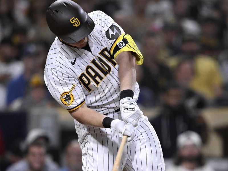 Aug 22, 2023; San Diego, California, USA; San Diego Padres first baseman Garrett Cooper (24) hits a double against the Miami Marlins during the eighth inning at Petco Park. Mandatory Credit: Orlando Ramirez-USA TODAY Sports