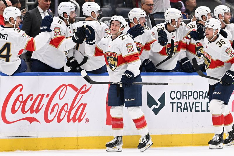 Oct 26, 2024; Elmont, New York, USA;  Florida Panthers right wing Mackie Samoskevich (25) celebrates his goal against the New York Islanders during the second period at UBS Arena. Mandatory Credit: Dennis Schneidler-Imagn Images