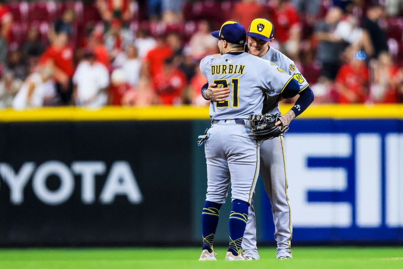 Aug 16, 2025; Cincinnati, Ohio, USA; Milwaukee Brewers second baseman Caleb Durbin (21) hugs shortstop Brice Turang (2) after the victory over the Cincinnati Reds at Great American Ball Park. Mandatory Credit: Katie Stratman-Imagn Images