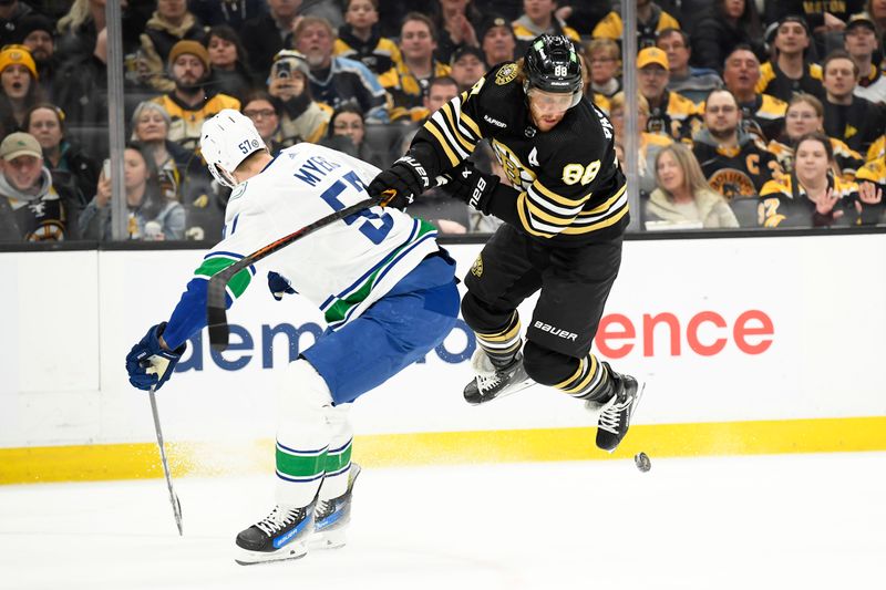 Feb 8, 2024; Boston, Massachusetts, USA; Boston Bruins right wing David Pastrnak (88) tries to stick handle past Vancouver Canucks defenseman Tyler Myers (57) during the first period at TD Garden. Mandatory Credit: Bob DeChiara-USA TODAY Sports