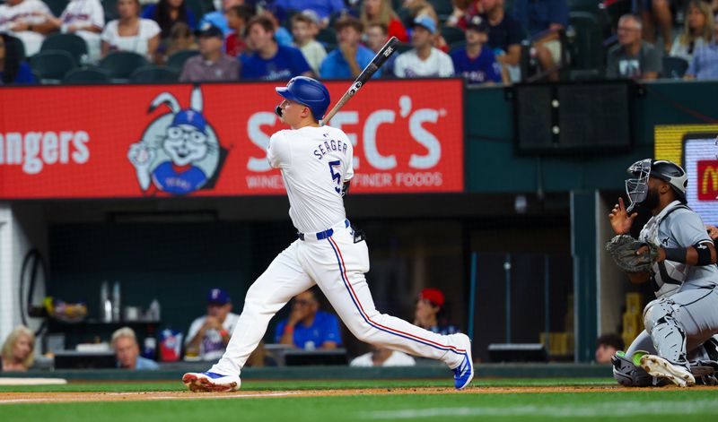 Jul 24, 2024; Arlington, Texas, USA; Texas Rangers shortstop Corey Seager (5) hits a home run during the first inning against the Chicago White Sox at Globe Life Field. Mandatory Credit: Kevin Jairaj-USA TODAY Sports