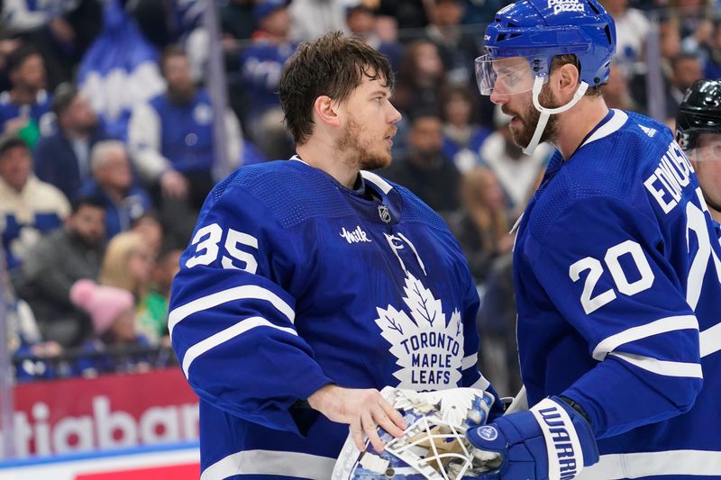 Apr 24, 2024; Toronto, Ontario, CAN; Toronto Maple Leafs defenseman Joel Edmundson (20) talks to goaltender Ilya Samsonov (35) during a break in the action against the Boston Bruins during the second period of game three of the first round of the 2024 Stanley Cup Playoffs at Scotiabank Arena. Mandatory Credit: John E. Sokolowski-USA TODAY Sports