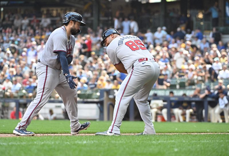 Jul 31, 2024; Milwaukee, Wisconsin, USA; Atlanta Braves catcher Travis d'Arnaud (16) celebrates with third base coach Matt Tuiasosopo (89) after hitting a home run against the Milwaukee Brewers in the seventh inning at American Family Field. Mandatory Credit: Michael McLoone-USA TODAY Sports