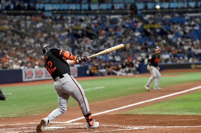 Aug 9, 2024; St. Petersburg, Florida, USA; Baltimore Orioles first base Ryan O’Hearn (32) hits a two run RBI single in the fifth inning against the Tampa Bay Rays at Tropicana Field. Mandatory Credit: Jonathan Dyer-USA TODAY Sports