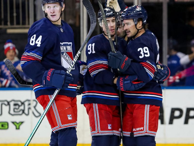 Nov 3, 2024; New York, New York, USA;New York Rangers center Adam Edstrom (84) celebrates his goal with right wing Reilly Smith (91) and center Sam Carrick (39) during the third period against the New York Islanders at Madison Square Garden. Mandatory Credit: Danny Wild-Imagn Images