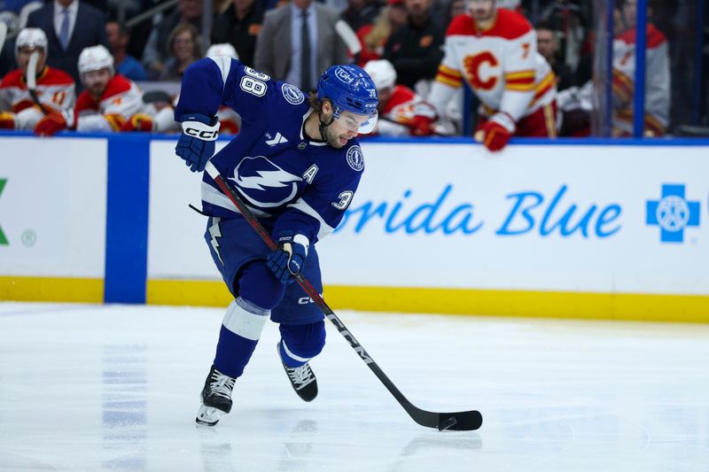 Nov 26, 2025; Tampa, Florida, USA; Tampa Bay Lightning left wing Brandon Hagel (38) controls the puck against the Calgary Flames in the first period at Benchmark International Arena. Mandatory Credit: Nathan Ray Seebeck-Imagn Images