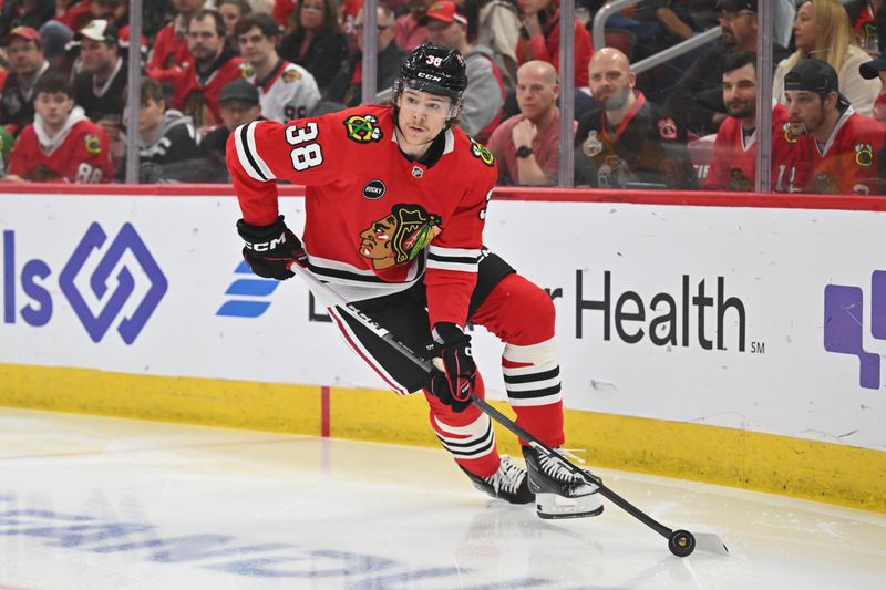 Apr 12, 2024; Chicago, Illinois, USA; Chicago Blackhawks defenseman Ethan Del Mastro (38) controls the puck on his first NHL shift in the first period against the Nashville Predators at United Center. Mandatory Credit: Jamie Sabau-USA TODAY Sports