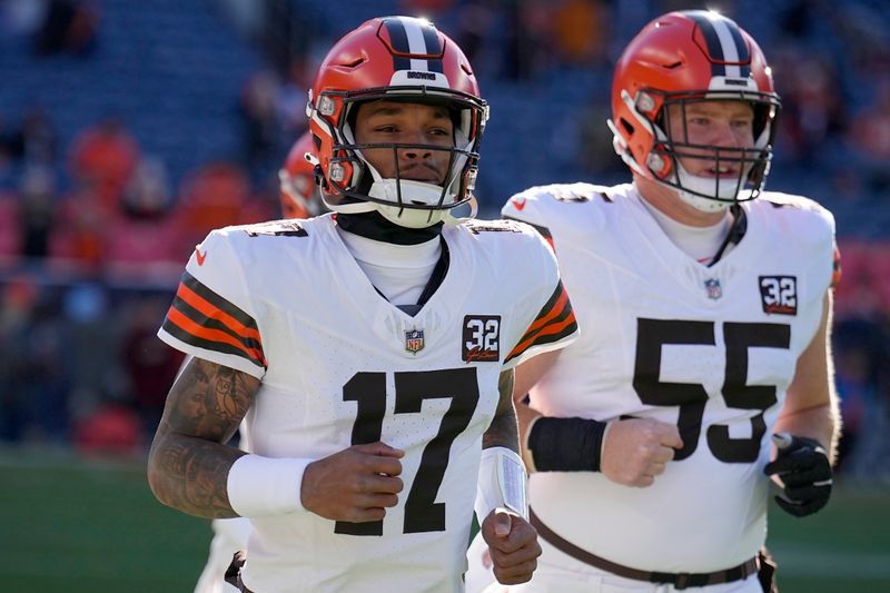 Cleveland Browns quarterback Dorian Thompson-Robinson (17) and center Ethan Pocic (55) warm up before the start of an NFL football game between the Cleveland Browns and the Denver Broncos on Sunday, Nov. 26, 2023, in Denver. (AP Photo/Jack Dempsey)