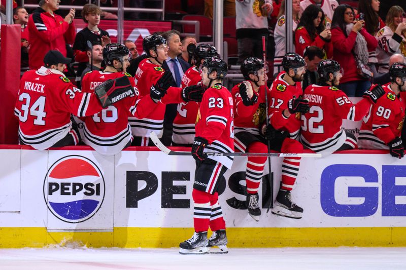 Dec 10, 2023; Chicago, Illinois, USA; Chicago Blackhawks center Philipp Kurashev (23) celebrates his goal with teammates against the Washington Capitals during the second period at the United Center. Mandatory Credit: Daniel Bartel-USA TODAY Sports