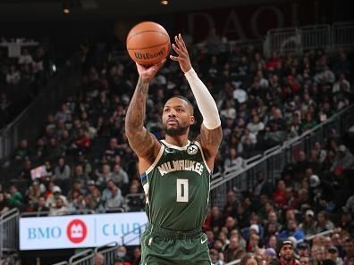 MILWAUKEE, WI - DECEMBER 11:  Damian Lillard #0 of the Milwaukee Bucks shoots a three point basket during the game  on December 11, 2023 at the Fiserv Forum Center in Milwaukee, Wisconsin. NOTE TO USER: User expressly acknowledges and agrees that, by downloading and or using this Photograph, user is consenting to the terms and conditions of the Getty Images License Agreement. Mandatory Copyright Notice: Copyright 2023 NBAE (Photo by Gary Dineen/NBAE via Getty Images).