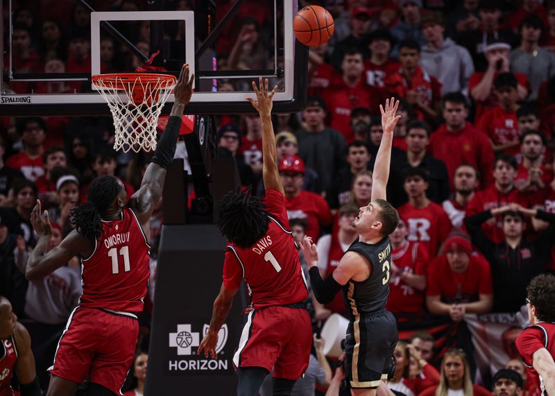 Jan 28, 2024; Piscataway, New Jersey, USA; Purdue Boilermakers guard Braden Smith (3) shoots the ball as Rutgers Scarlet Knights guard Jamichael Davis (1) and Rutgers Scarlet Knights center Clifford Omoruyi (11) defend during the second half at Jersey Mike's Arena. Mandatory Credit: Vincent Carchietta-USA TODAY Sports