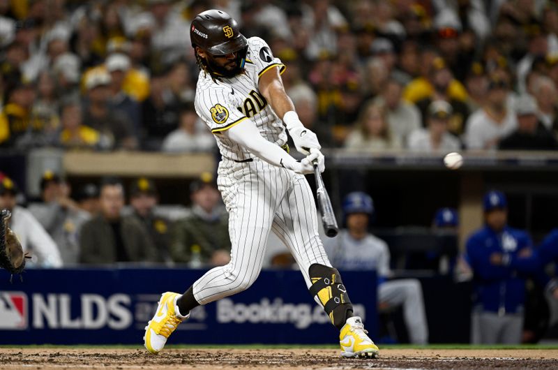Oct 9, 2024; San Diego, California, USA; San Diego Padres outfielder Fernando Tatis Jr. (23) doubles in the third inning against the Los Angeles Dodgers during game four of the NLDS for the 2024 MLB Playoffs at Petco Park.  Mandatory Credit: Denis Poroy-Imagn Images