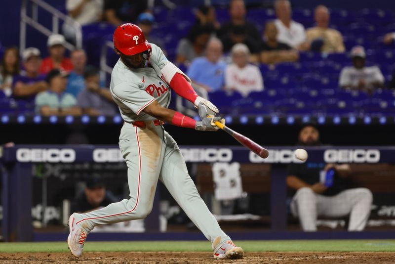 Sep 6, 2024; Miami, Florida, USA; Philadelphia Phillies center fielder Johan Rojas (18) hits an RBI double against the Miami Marlins during the fifth inning at loanDepot Park. Mandatory Credit: Sam Navarro-Imagn Images