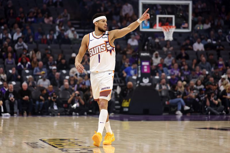 SACRAMENTO, CALIFORNIA - NOVEMBER 13: Devin Booker #1 of the Phoenix Suns points to a teammate in the first half of their game against the Sacramento Kings at Golden 1 Center on November 13, 2024 in Sacramento, California. NOTE TO USER: User expressly acknowledges and agrees that, by downloading and/or using this photograph, user is consenting to the terms and conditions of the Getty Images License Agreement.  (Photo by Ezra Shaw/Getty Images)