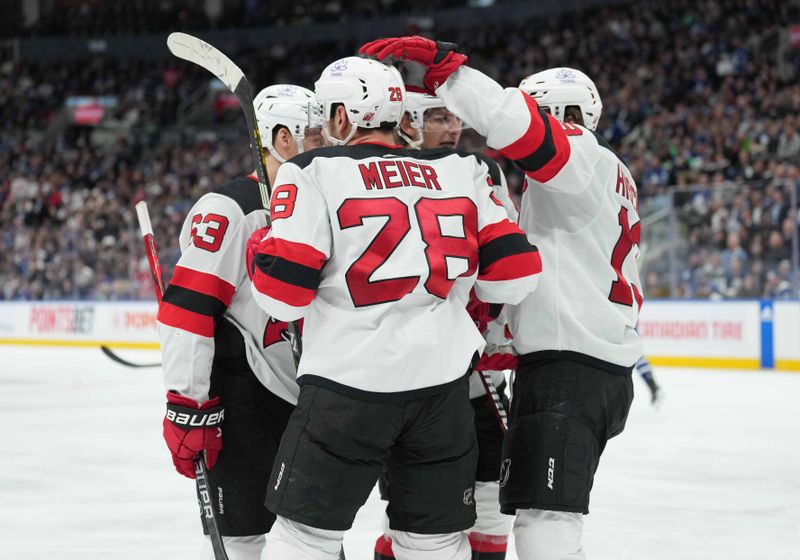 Mar 26, 2024; Toronto, Ontario, CAN; New Jersey Devils right wing Timo Meier (28) scores a gaol and celebrates with center Nico Hischier (13) against the Toronto Maple Leafs during the second period at Scotiabank Arena. Mandatory Credit: Nick Turchiaro-USA TODAY Sports