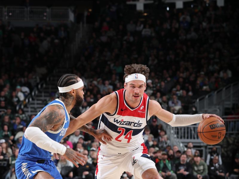 MILWAUKEE, WI - NOVEMBER 30: Corey Kispert #24 of the Washington Wizards drives to the basket during the game against the Milwaukee Bucks on November 30, 2024 at Fiserv Forum Center in Milwaukee, Wisconsin. NOTE TO USER: User expressly acknowledges and agrees that, by downloading and or using this Photograph, user is consenting to the terms and conditions of the Getty Images License Agreement. Mandatory Copyright Notice: Copyright 2024 NBAE (Photo by Gary Dineen/NBAE via Getty Images).