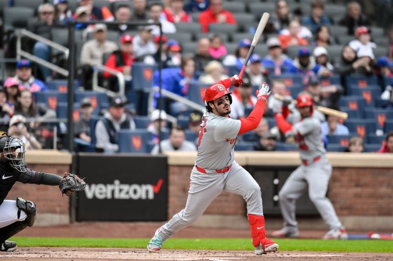 Apr 27, 2024; New York City, New York, USA; St. Louis Cardinals third baseman Nolan Arenado (28) hits a RBI single during the first inning against the New York Mets at Citi Field. Mandatory Credit: John Jones-USA TODAY Sports