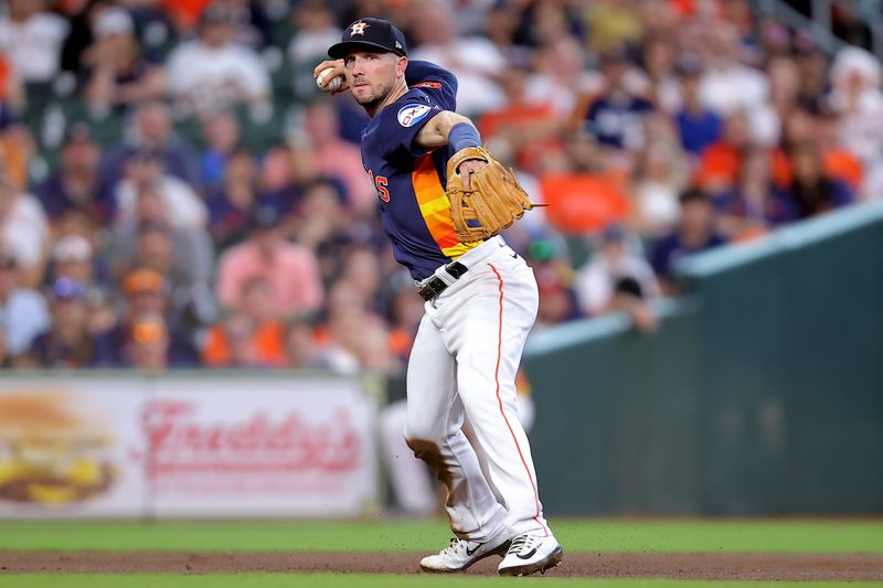 May 4, 2024; Houston, Texas, USA; Houston Astros third baseman Alex Bregman (2) throws a fielded ball to first base for an out against the Seattle Mariners during the second inning at Minute Maid Park. Mandatory Credit: Erik Williams-USA TODAY Sports