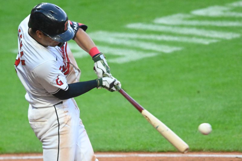 May 18, 2024; Cleveland, Ohio, USA; Cleveland Guardians center fielder Tyler Freeman (2) hits a two-RBI single in the seventh inning against the Minnesota Twins at Progressive Field. Mandatory Credit: David Richard-USA TODAY Sports