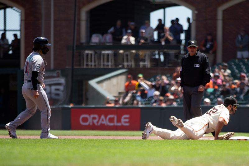 May 14, 2025; San Francisco, California, USA; San Francisco Giants first baseman David Villar (32) dives onto first base to double up Arizona Diamondbacks catcher Jose Herrera (11) on a line drive by Corbin Carroll during the second inning at Oracle Park. Mandatory Credit: D. Ross Cameron-Imagn Images