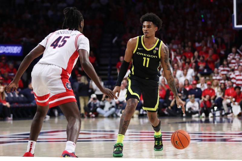 Feb 2, 2023; Tucson, Arizona, USA; Oregon Ducks guard Rivaldo Soares (11) makes a pass against Arizona Wildcats guard Cedric Henderson Jr. (45) in the first half at McKale Center. Mandatory Credit: Zachary BonDurant-USA TODAY Sports