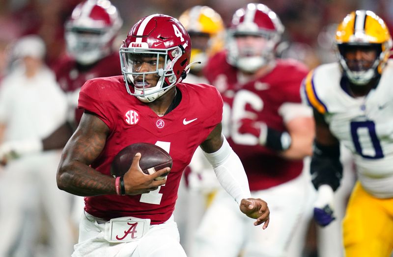 Nov 4, 2023; Tuscaloosa, Alabama, USA; Alabama Crimson Tide quarterback Jalen Milroe (4) scrambles up the field against the LSU Tigers during the second quarter at Bryant-Denny Stadium. Mandatory Credit: John David Mercer-USA TODAY Sports