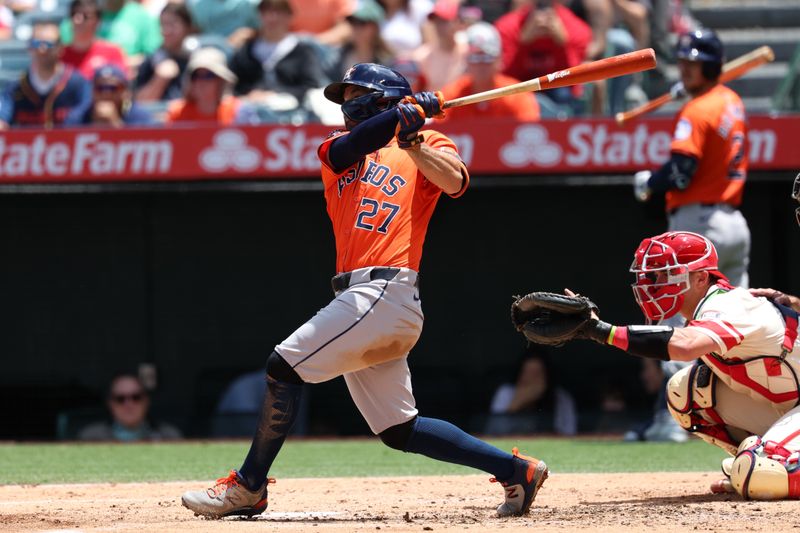 Jun 9, 2024; Anaheim, California, USA;  Houston Astros second baseman Jose Altuve (27) hits an RBI single during the third inning against the Los Angeles Angels at Angel Stadium. Mandatory Credit: Kiyoshi Mio-USA TODAY Sports