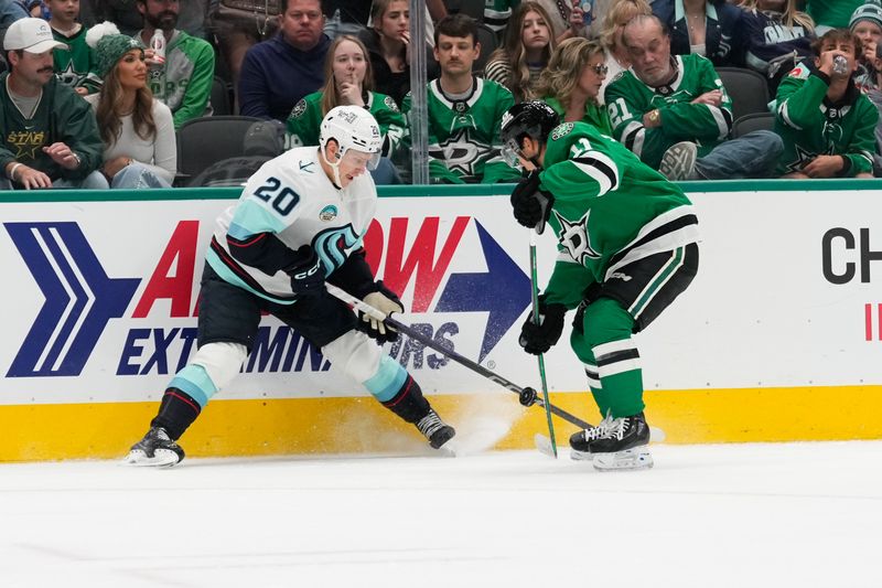 Oct 13, 2024; Dallas, Texas, USA;  Seattle Kraken right wing Eeli Tolvanen (20) and Dallas Stars center Logan Stankoven (11) battle for the puck during the second period at American Airlines Center. Mandatory Credit: Chris Jones-Imagn Images