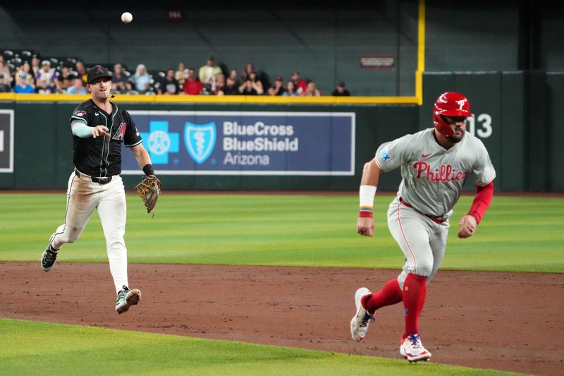Aug 8, 2024; Phoenix, Arizona, USA; Arizona Diamondbacks shortstop Kevin Newman (18) throws to first base after catching Philadelphia Phillies designated hitter Kyle Schwarber (12) in a run down during the third inning at Chase Field. Mandatory Credit: Joe Camporeale-USA TODAY Sports