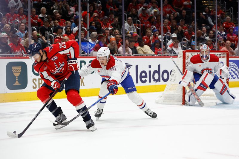 Oct 31, 2024; Washington, District of Columbia, USA; Washington Capitals center Nic Dowd (26) skates with the puck as Montreal Canadiens center Oliver Kapanen (91) defends in the first period at Capital One Arena. Mandatory Credit: Geoff Burke-Imagn Images