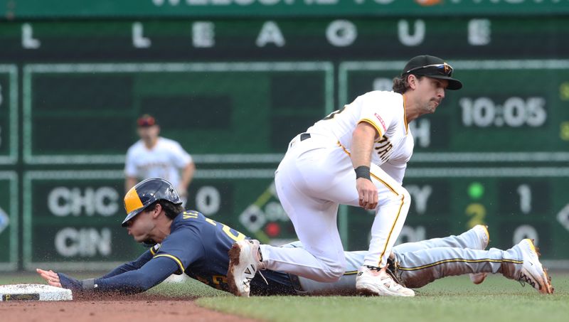 May 24, 2025; Pittsburgh, Pennsylvania, USA;  Milwaukee Brewers designated hitter  Christian Yelich (22) steals second base as Pittsburgh Pirates second baseman Adam Frazier (26) applies a late tag during the second inning at PNC Park. Mandatory Credit: Charles LeClaire-Imagn Images