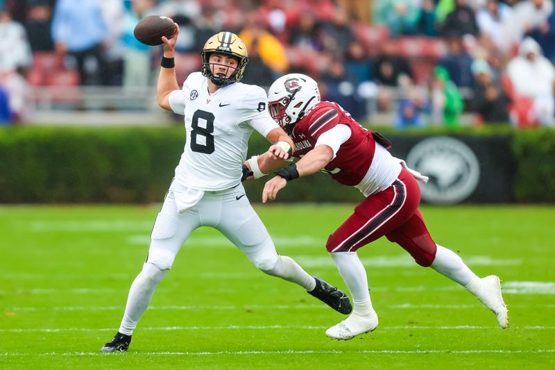 Nov 11, 2023; Columbia, South Carolina, USA; Vanderbilt Commodores quarterback Ken Seals (8) thows the ball before being hit by South Carolina Gamecocks linebacker Jaron Willis (14) in the second quarter at Williams-Brice Stadium. Mandatory Credit: Jeff Blake-USA TODAY Sports