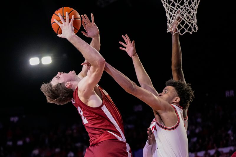 Jan 31, 2024; Athens, Georgia, USA; Alabama Crimson Tide forward Grant Nelson (2) is defended at the basket by Georgia Bulldogs guard Jabri Abdur-Rahim (1) during the second half at Stegeman Coliseum. Mandatory Credit: Dale Zanine-USA TODAY Sports