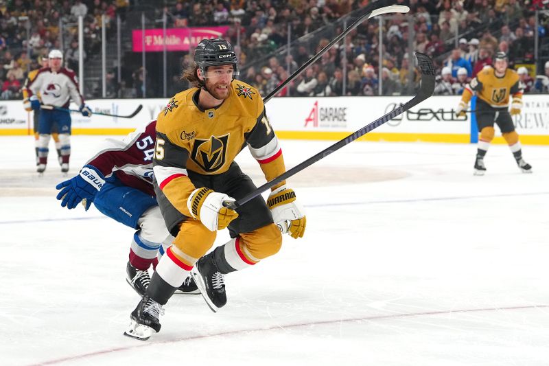 Dec 27, 2025; Las Vegas, Nevada, USA; Vegas Golden Knights defenseman Noah Hanifin (15) skates ahead of Colorado Avalanche center Gavin Brindley (54) during the first period at T-Mobile Arena. Mandatory Credit: Stephen R. Sylvanie-Imagn Images