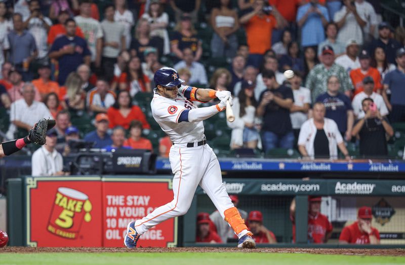 May 21, 2024; Houston, Texas, USA; Houston Astros shortstop Jeremy Pena (3) hits a walk-off RBI single during the tenth inning against the Los Angeles Angels at Minute Maid Park. Mandatory Credit: Troy Taormina-USA TODAY Sports