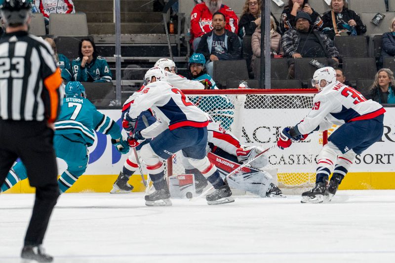 Nov 27, 2023; San Jose, California, USA; Washington Capitals goaltender Darcy Kuemper (35) makes a save against San Jose Sharks center Nico Sturm (7) during the first period at SAP Center at San Jose. Mandatory Credit: Neville E. Guard-USA TODAY Sports